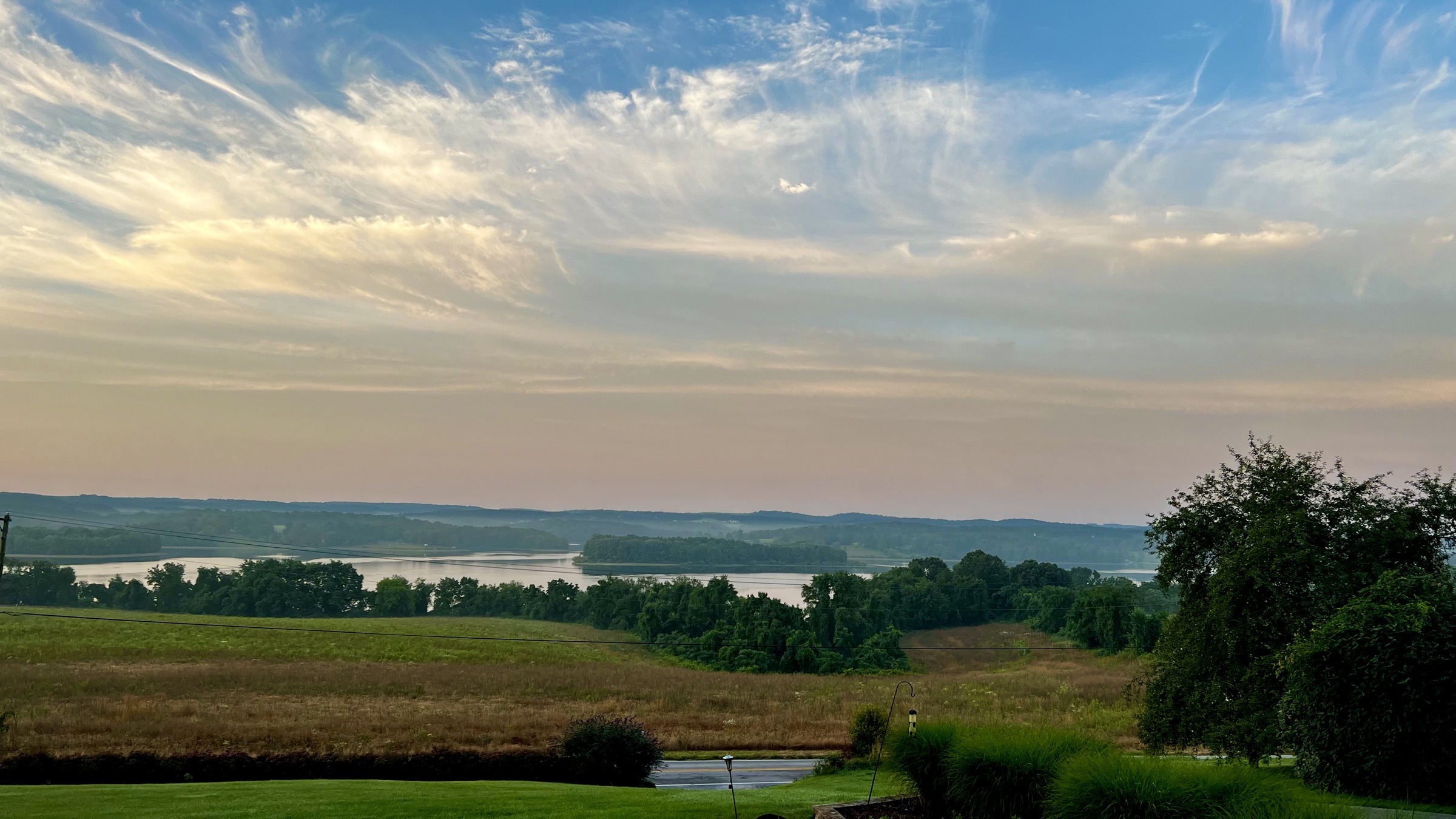 Morning light over rolling farmland and the lake outside Hanover, PA